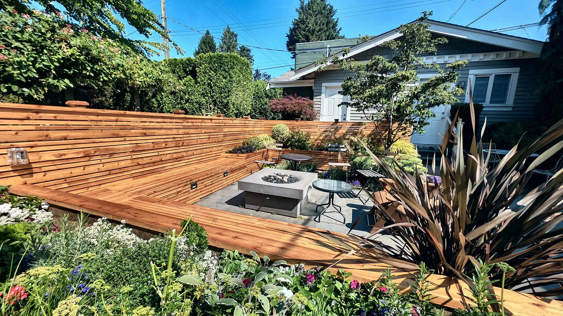 Built-in cedar bench against the fence
