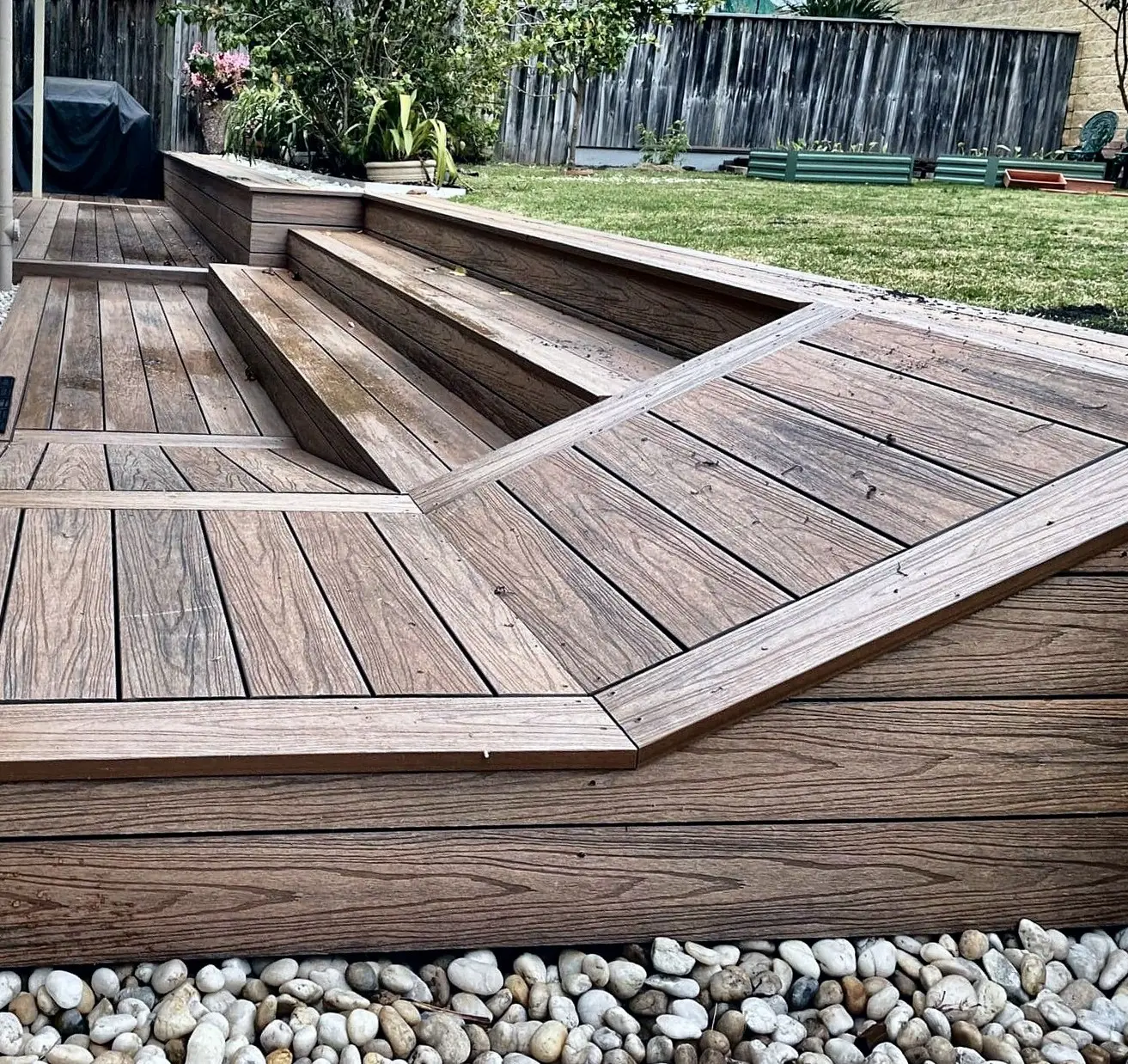 Ground-level composite deck with a built-in step