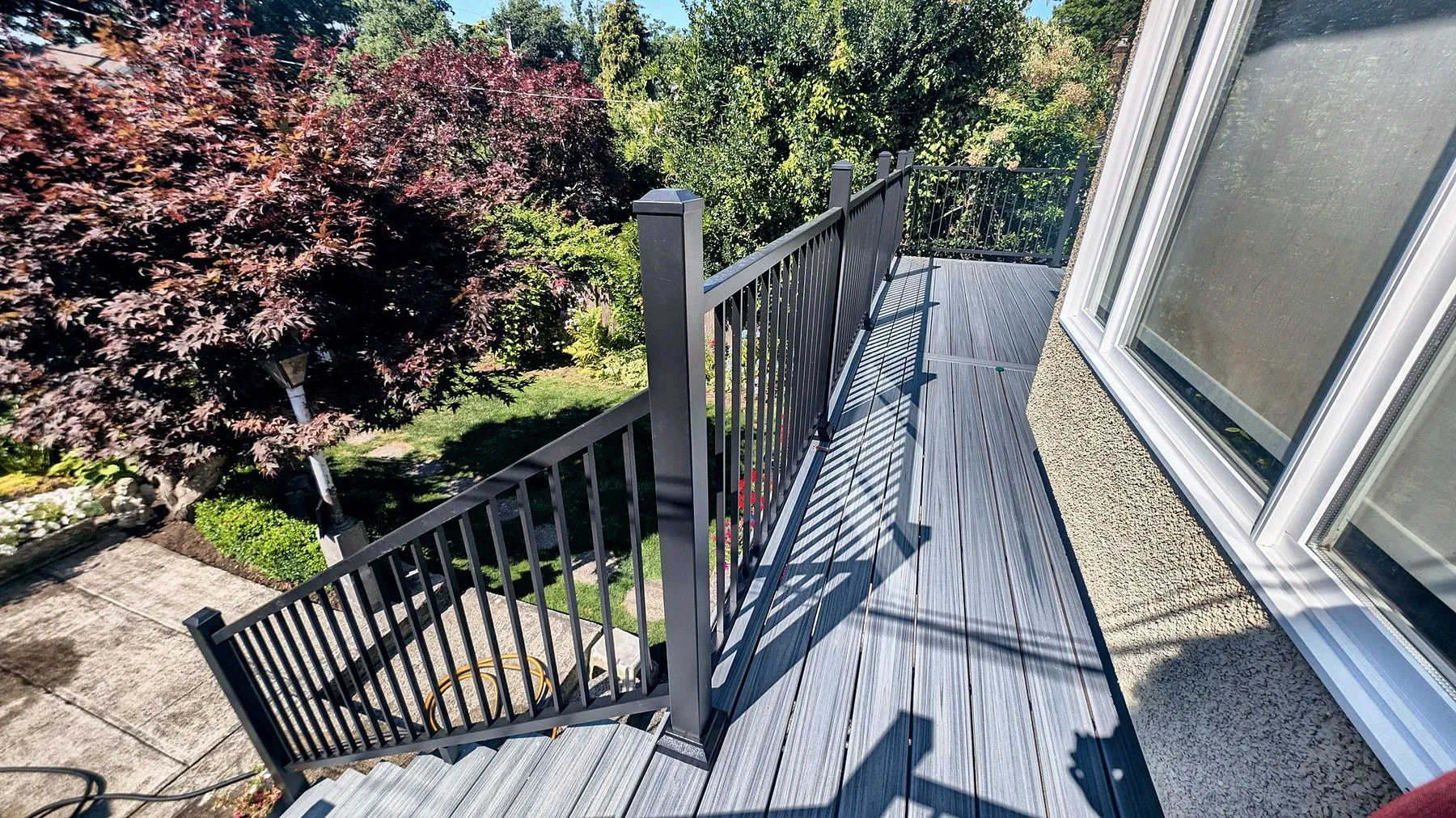 Black aluminum railing on a composite deck