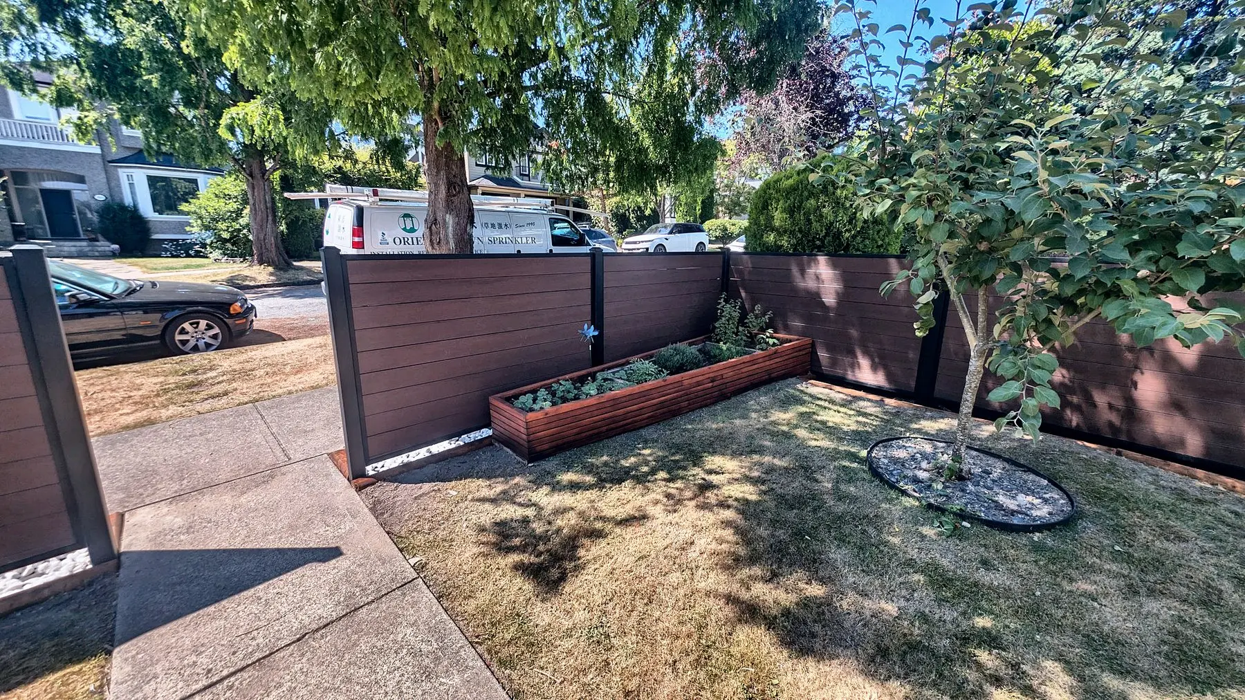 The fence from inside the yard, with the planter beds