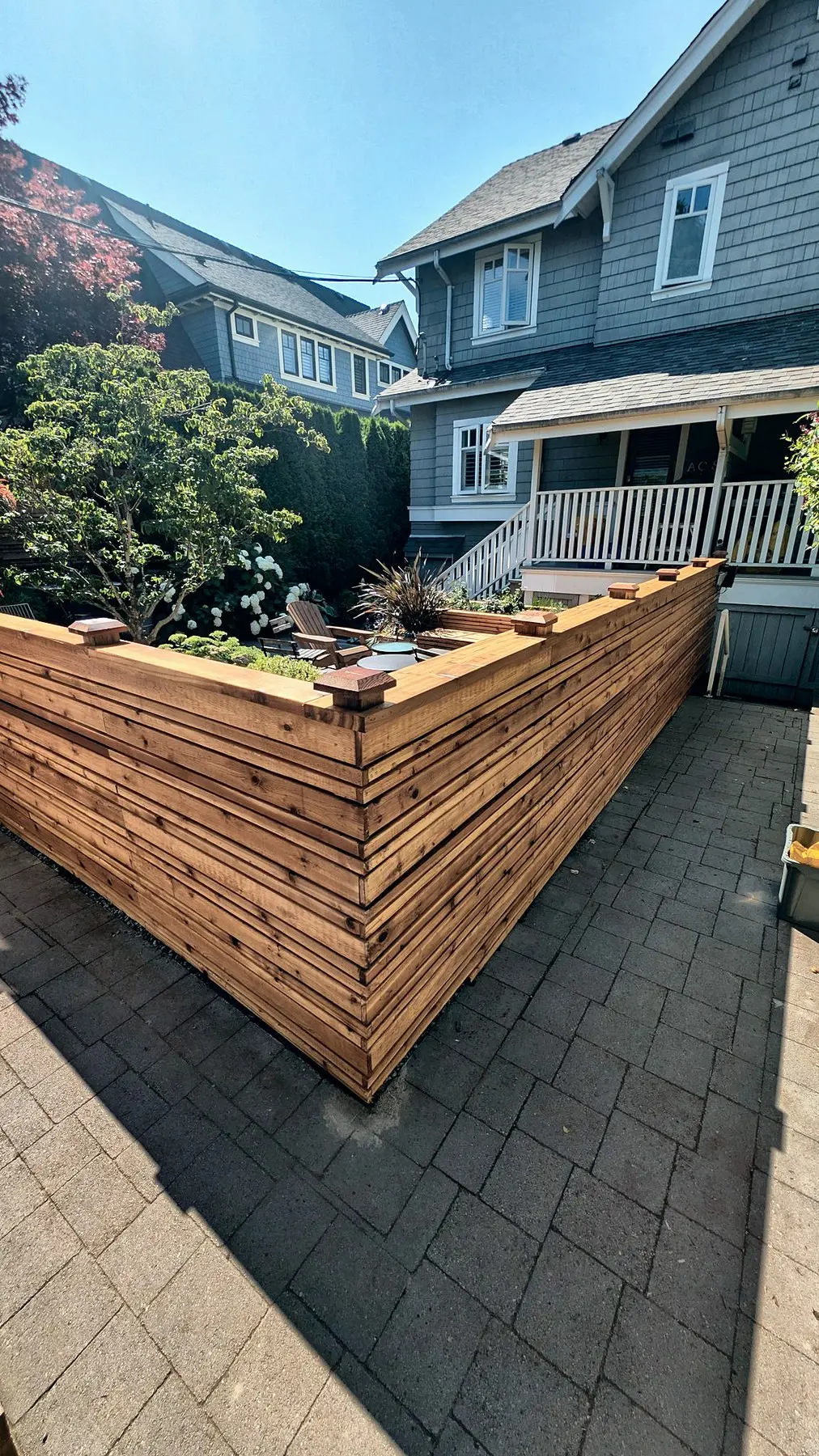 Horizontal cedar fence along the side of the house