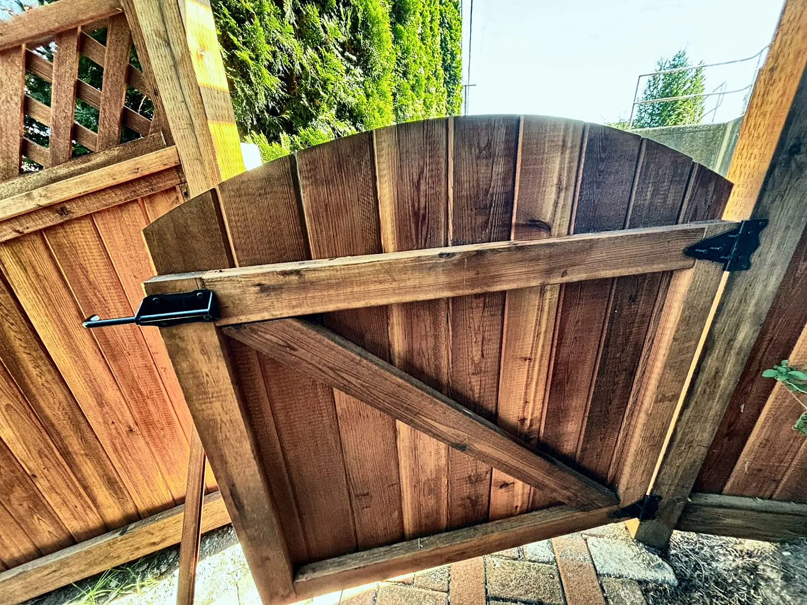 Arched cedar gate with heavy black hardware, Coquitlam