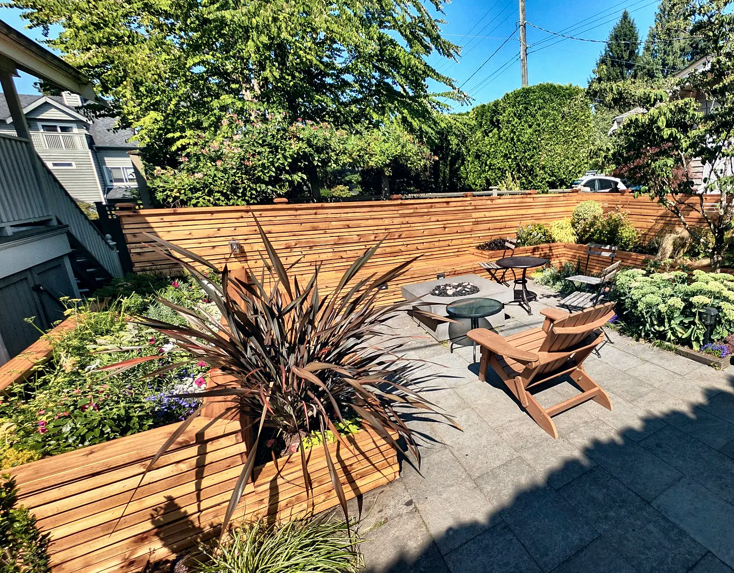 Horizontal cedar fence and patio with a fire table