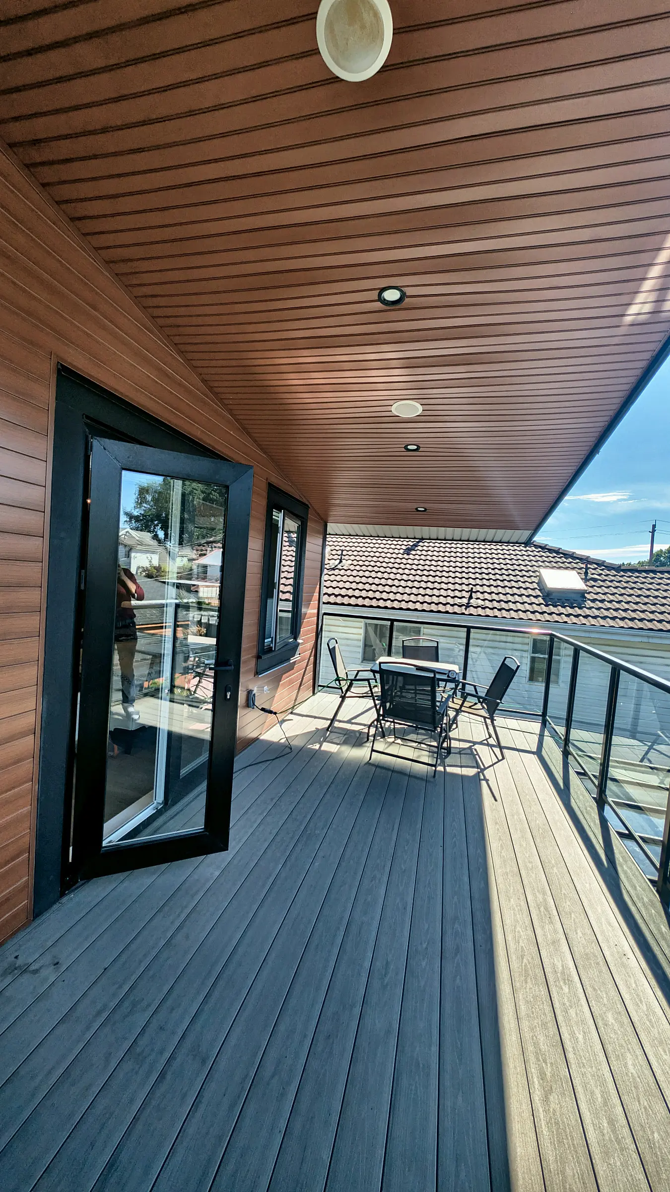 The rooftop deck, cedar soffit and glass railing