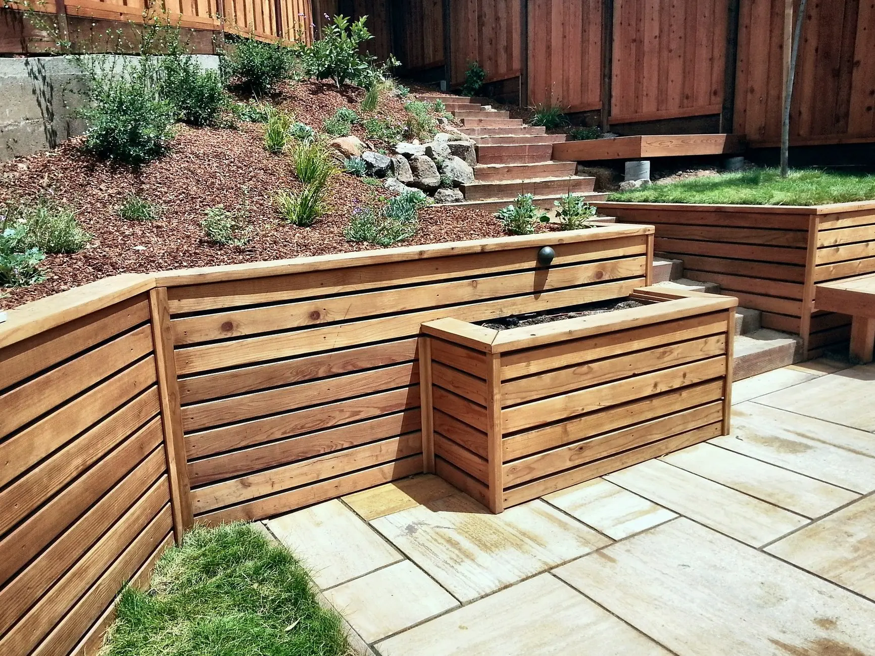 Cedar retaining wall with built-in planters on a terraced yard